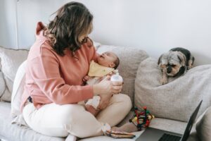 faceless woman with little baby and dog